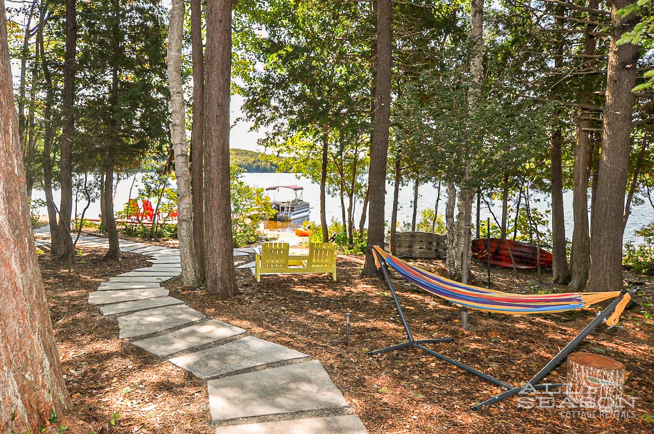 Swing gently in your private hammock while soaking up serene lake views through the trees—pure relaxation awaits.