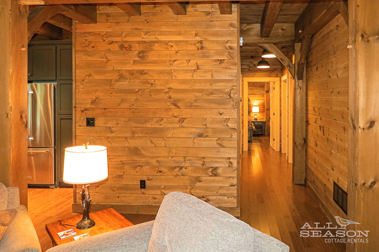 Cozy up in your rustic cabin retreat where warm wood beams and soft lighting create the perfect atmosphere for relaxation.