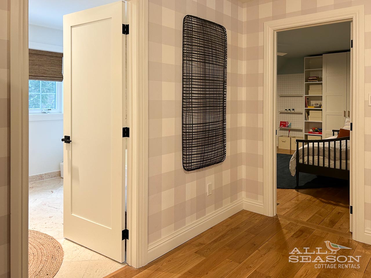 Your elegant hallway connects private spaces with warm wood floors and thoughtful design details throughout.