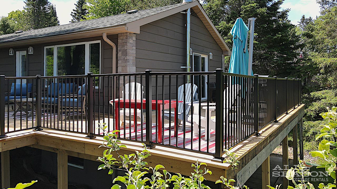 Relax on your private deck with outdoor seating while surrounded by lush greenery and natural beauty.