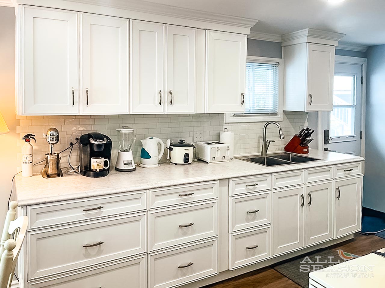 Your fully equipped kitchen features pristine white cabinets, modern appliances, and everything you need to prepare delicious meals during your stay.
