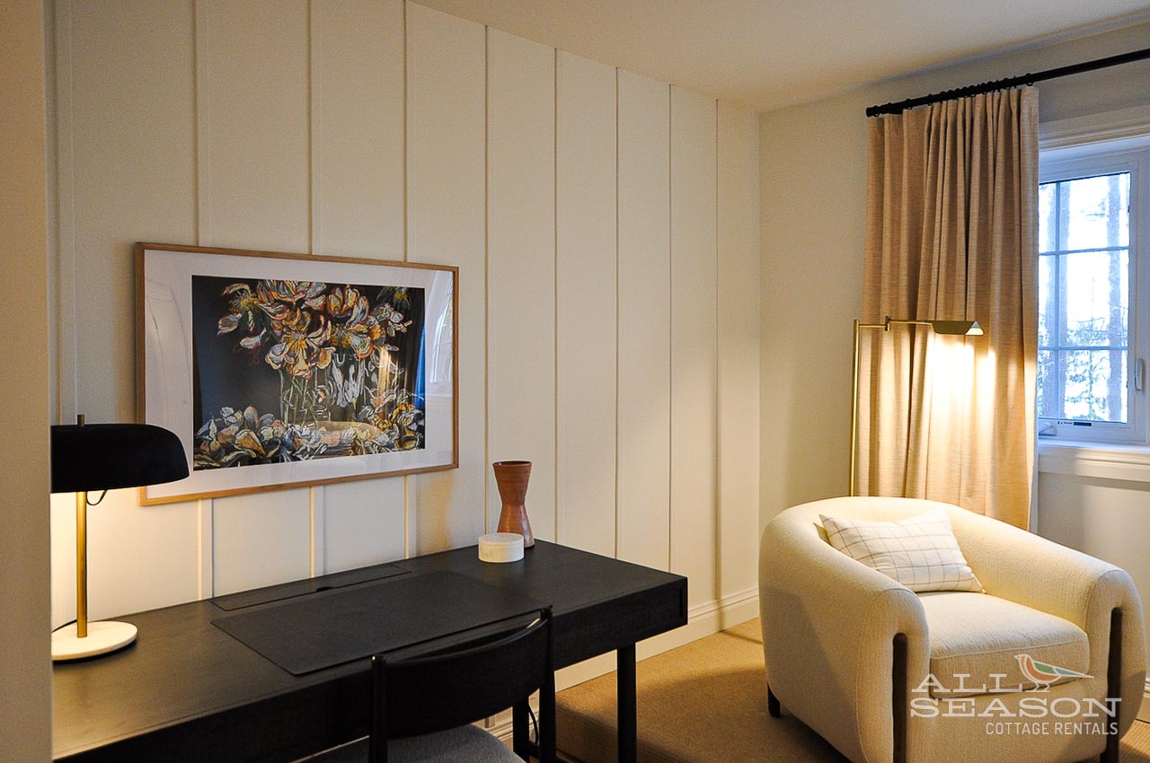 Settle into your own quiet corner with a sleek desk for catching up on work and a plush reading chair bathed in golden light.