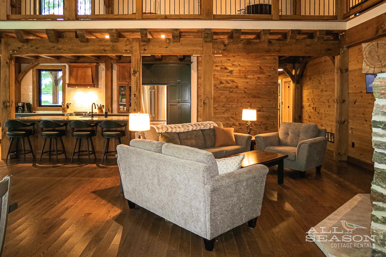 Unwind in your rustic-chic haven where exposed beams meet modern comfort. Plush seating invites cozy evenings by warm lighting.