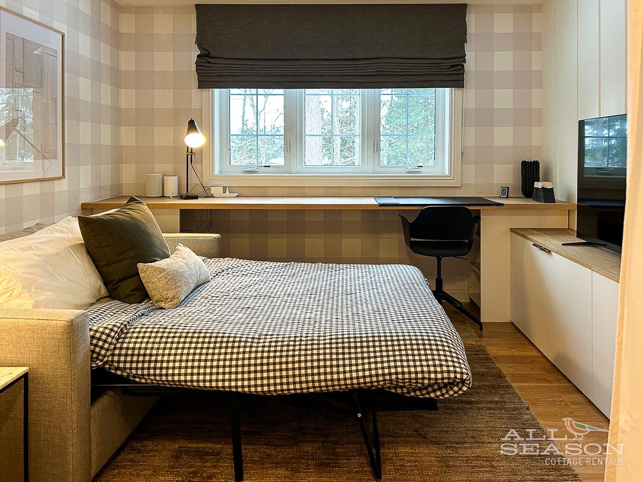 Your cozy living space transforms into a comfortable bedroom with a pull-out sofa bed, perfect workspace, and peaceful garden views.