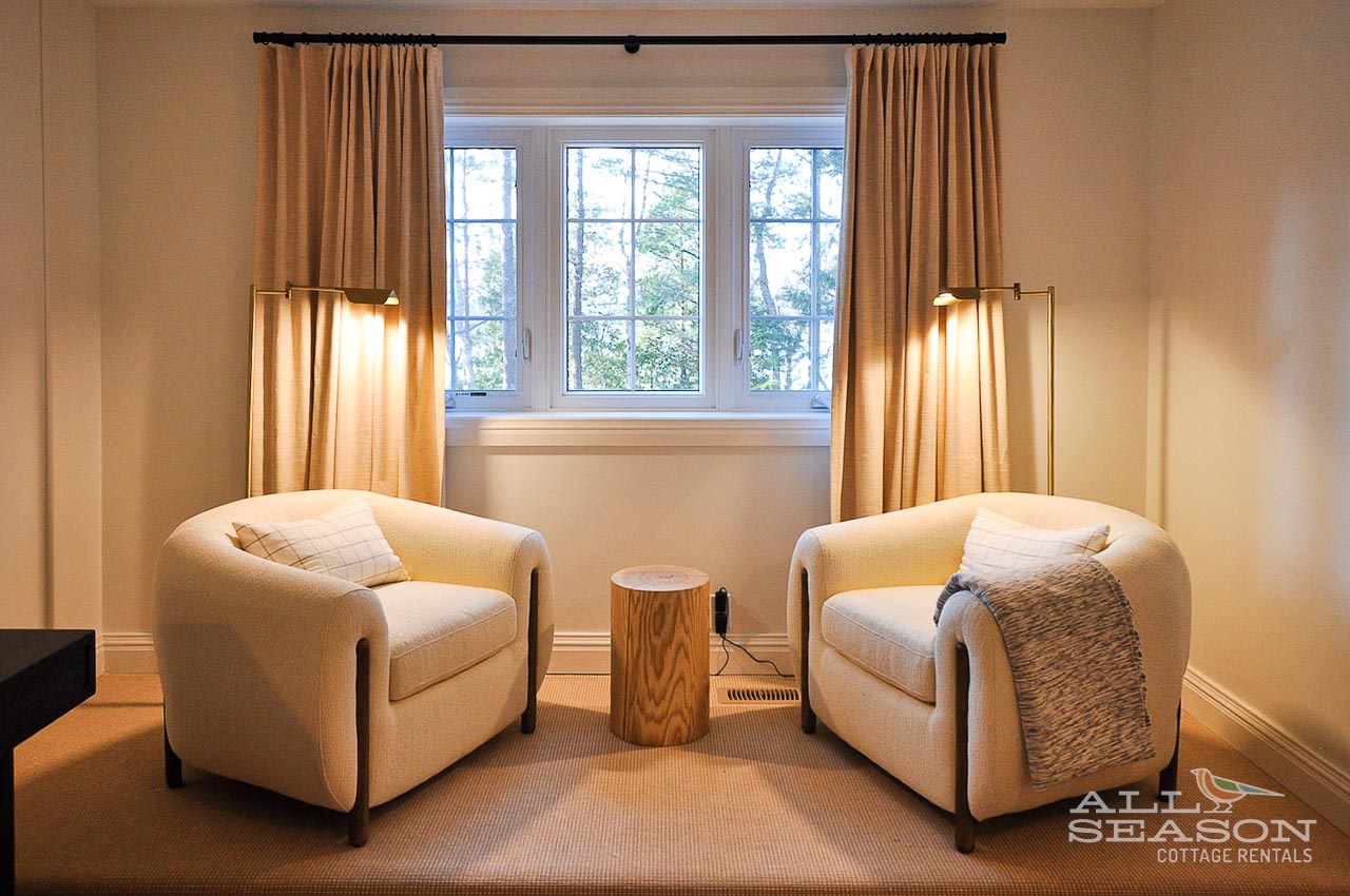 Sink into these plush reading chairs by your window, where warm light and garden views create your perfect relaxation retreat.