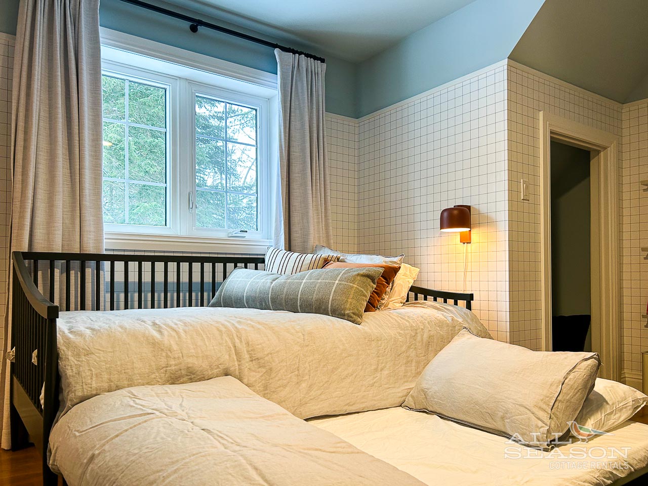 Drift off to peaceful sleep in your cozy bedroom with soft linens and natural light filtering through leafy windows.