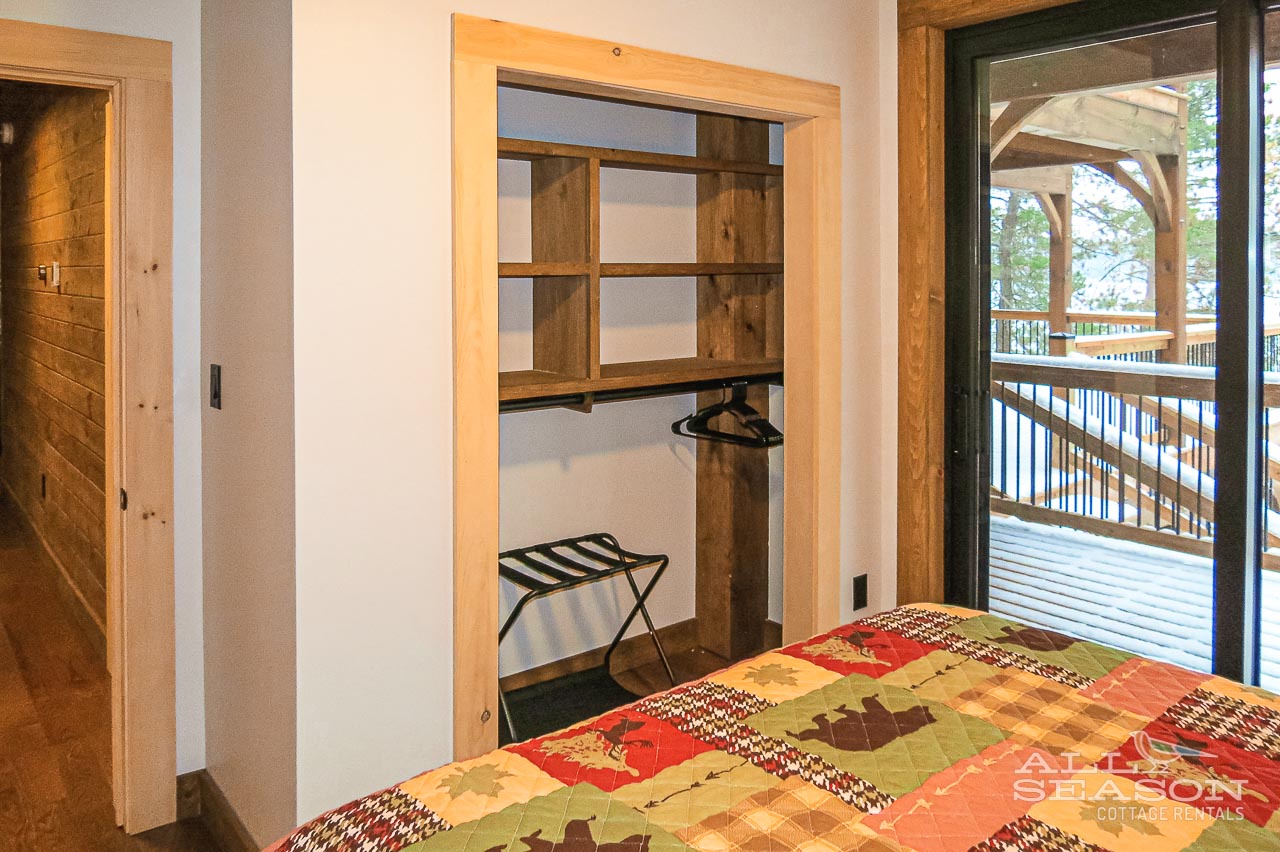 Your spacious bedroom features rustic wood touches and thoughtful storage with a walk-in closet for easy organizing during your stay.