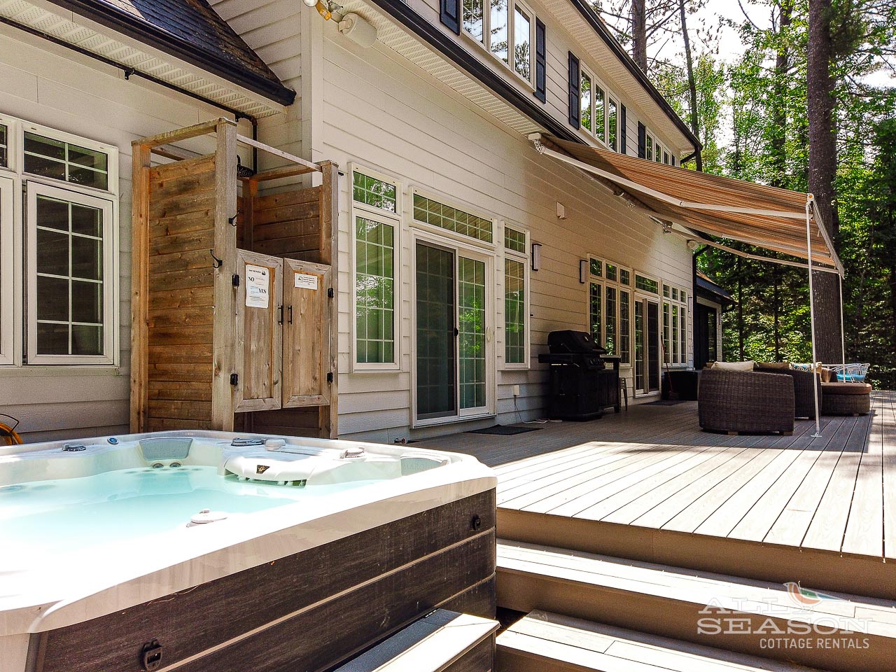 Soak in your private hot tub on this spacious deck, surrounded by tall trees and equipped with BBQ for perfect outdoor entertaining.