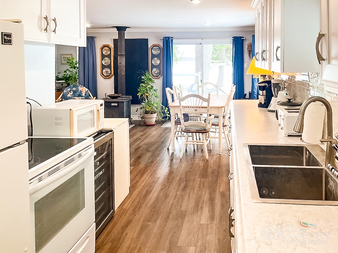 Cook your favorite meals in this spacious, fully equipped kitchen with modern appliances and cozy dining area.