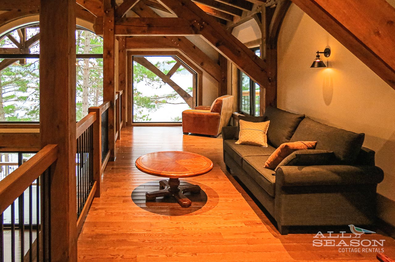Unwind in your cozy loft lounge with exposed timber beams and forest views through picture windows.