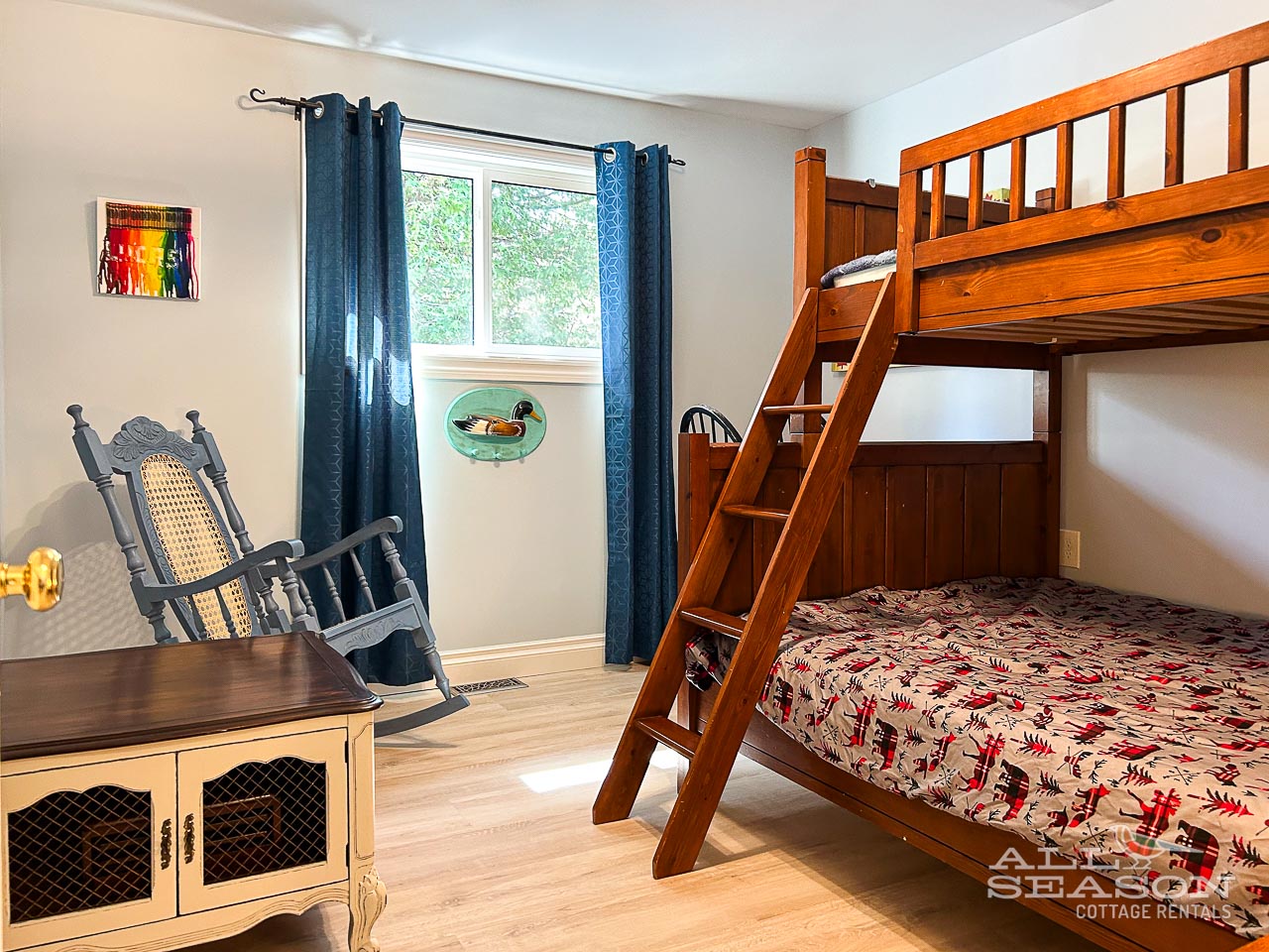 Settle into this cozy bedroom with rustic bunk beds, where you can enjoy leafy views and charming details.