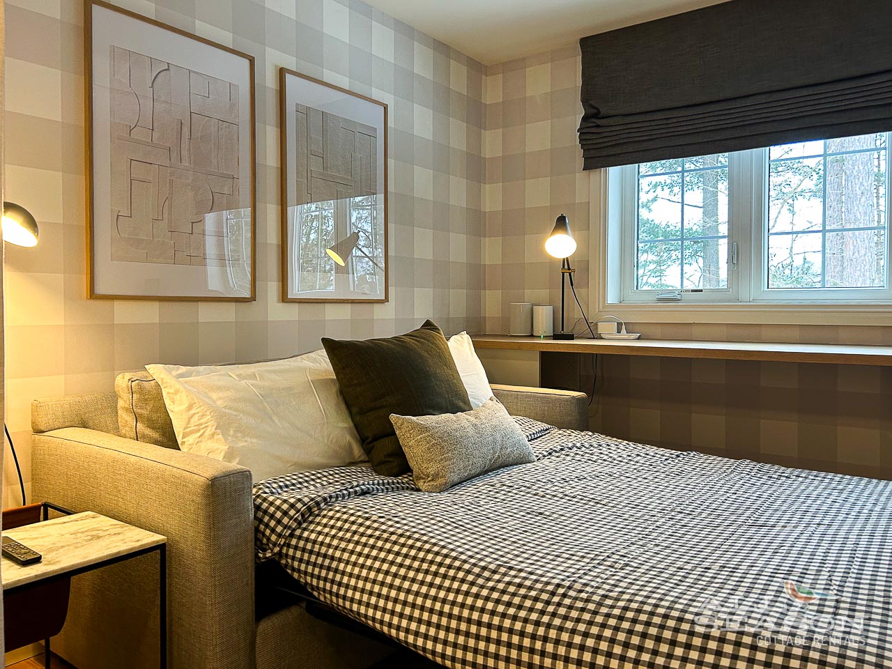 Sink into your cozy sofa bed surrounded by warm checkered walls and natural light streaming through garden views.