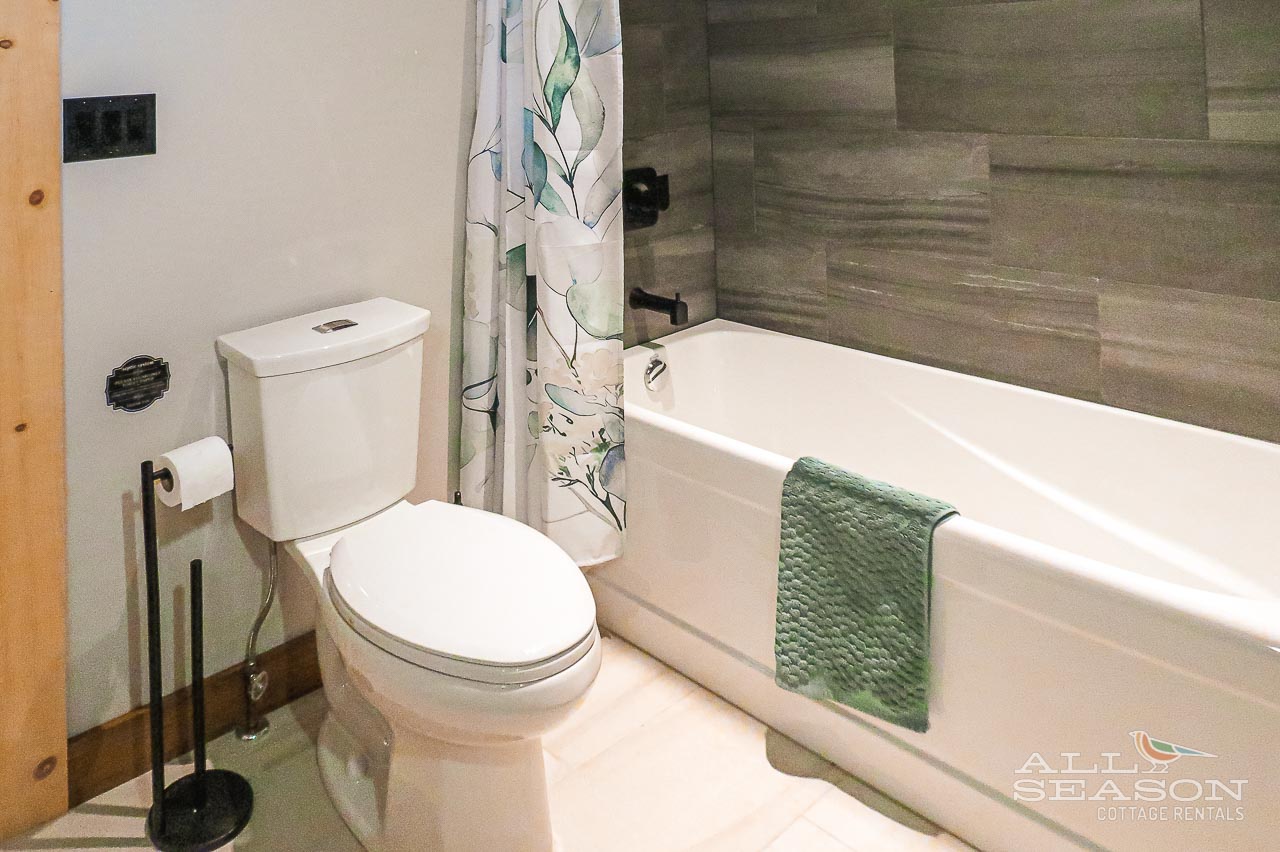 Unwind in your sleek bathroom featuring a soaking tub and nature-inspired touches that create your personal spa retreat.