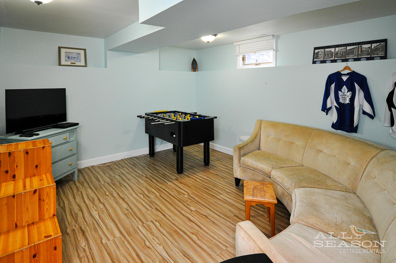 Unwind in your private rec room with foosball table and comfy seating for game nights.