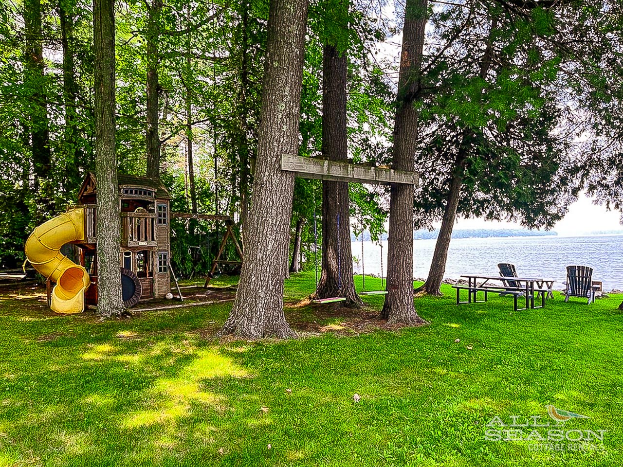Relax on your private lakefront lawn with playground fun and peaceful water views for unforgettable family memories.