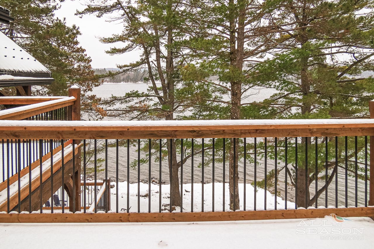 Step onto your private deck and breathe in the crisp winter air while taking in stunning lake views through towering pines.