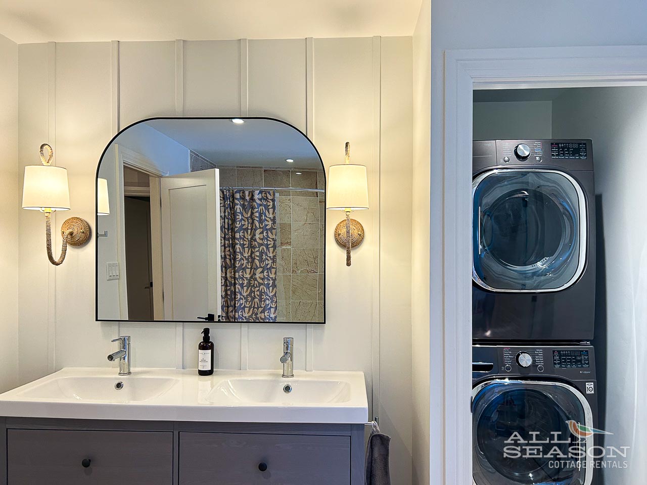 Your stylish bathroom features dual sinks and elegant gold accents, with convenient in-unit laundry just steps away for ultimate comfort.