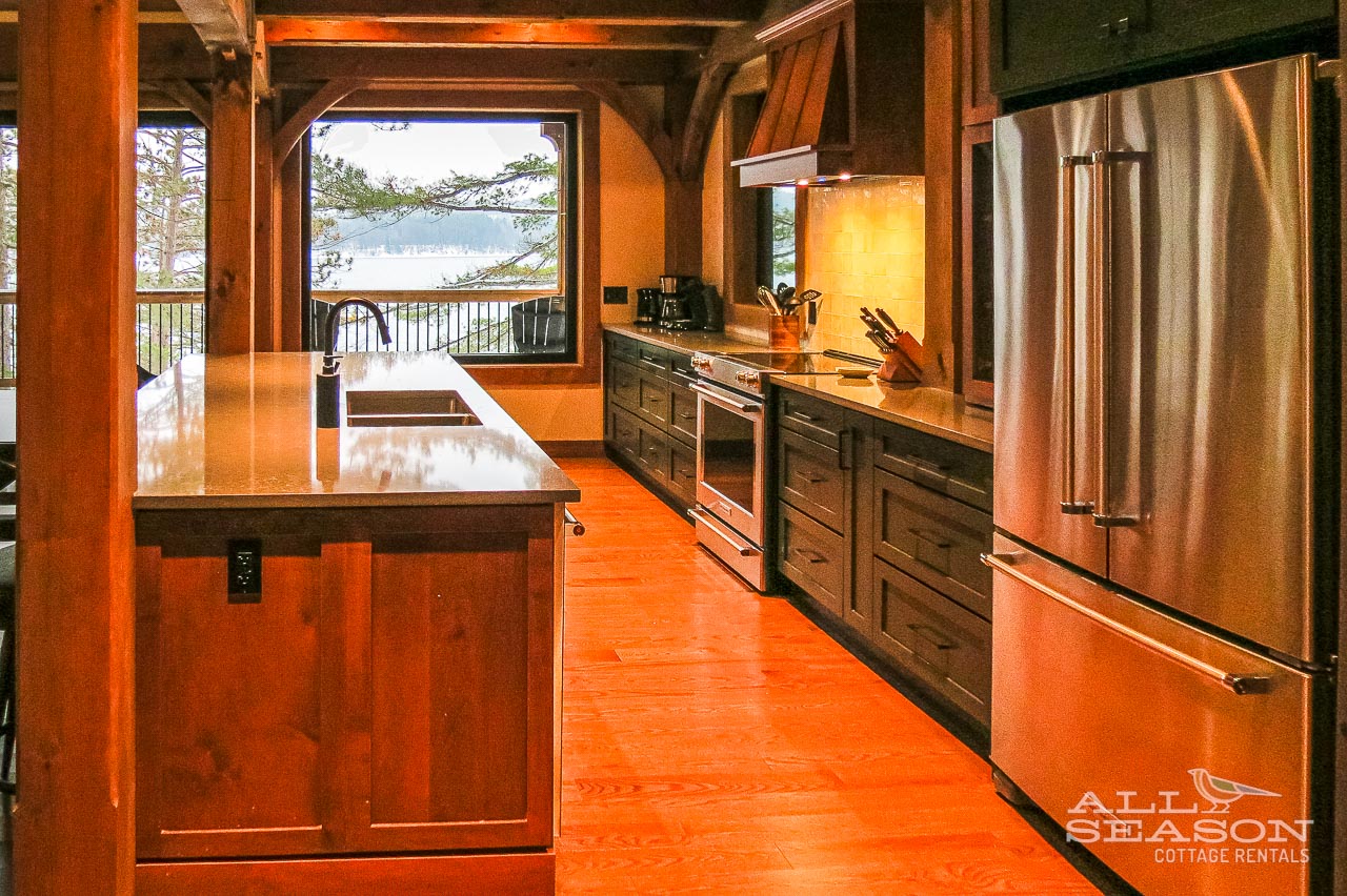 Your spacious gourmet kitchen features modern appliances and stunning lake views, perfect for creating memorable meals during your getaway.