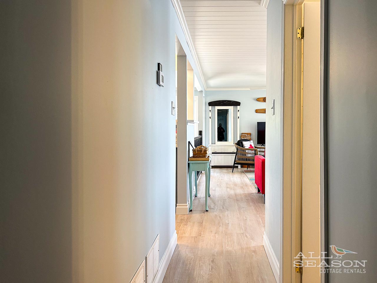 Step into your bright, welcoming hallway with gleaming hardwood floors leading to the spacious living area beyond.