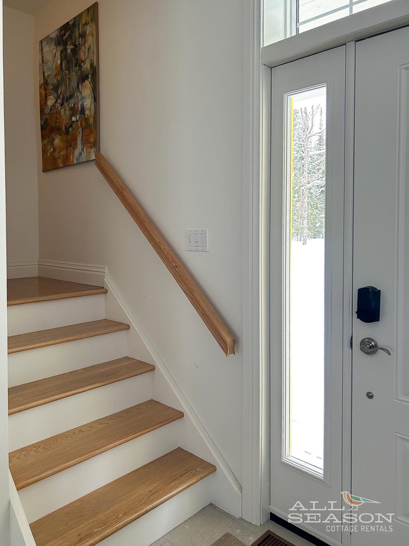 Step into your private entrance where warm wood accents and natural light create a welcoming first impression of your getaway.