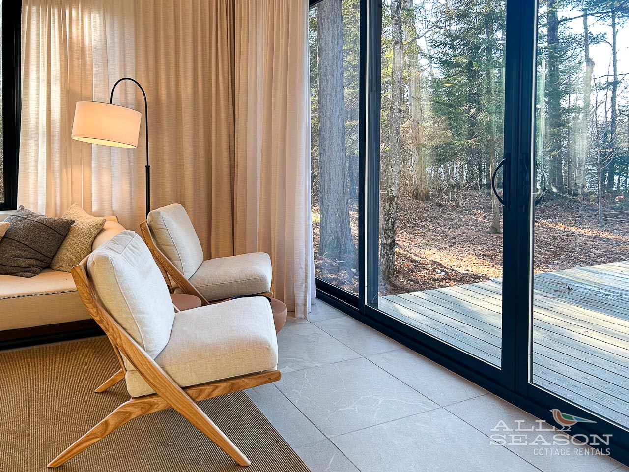 Sink into plush armchairs by floor-to-ceiling windows, where forest views create your private nature retreat.