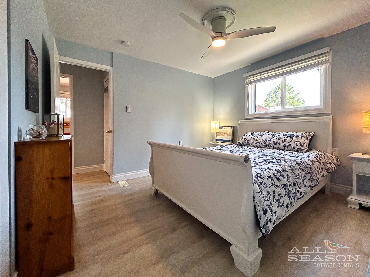 Settle into your peaceful bedroom where soft blue walls and elegant furnishings create the perfect retreat for restful nights.