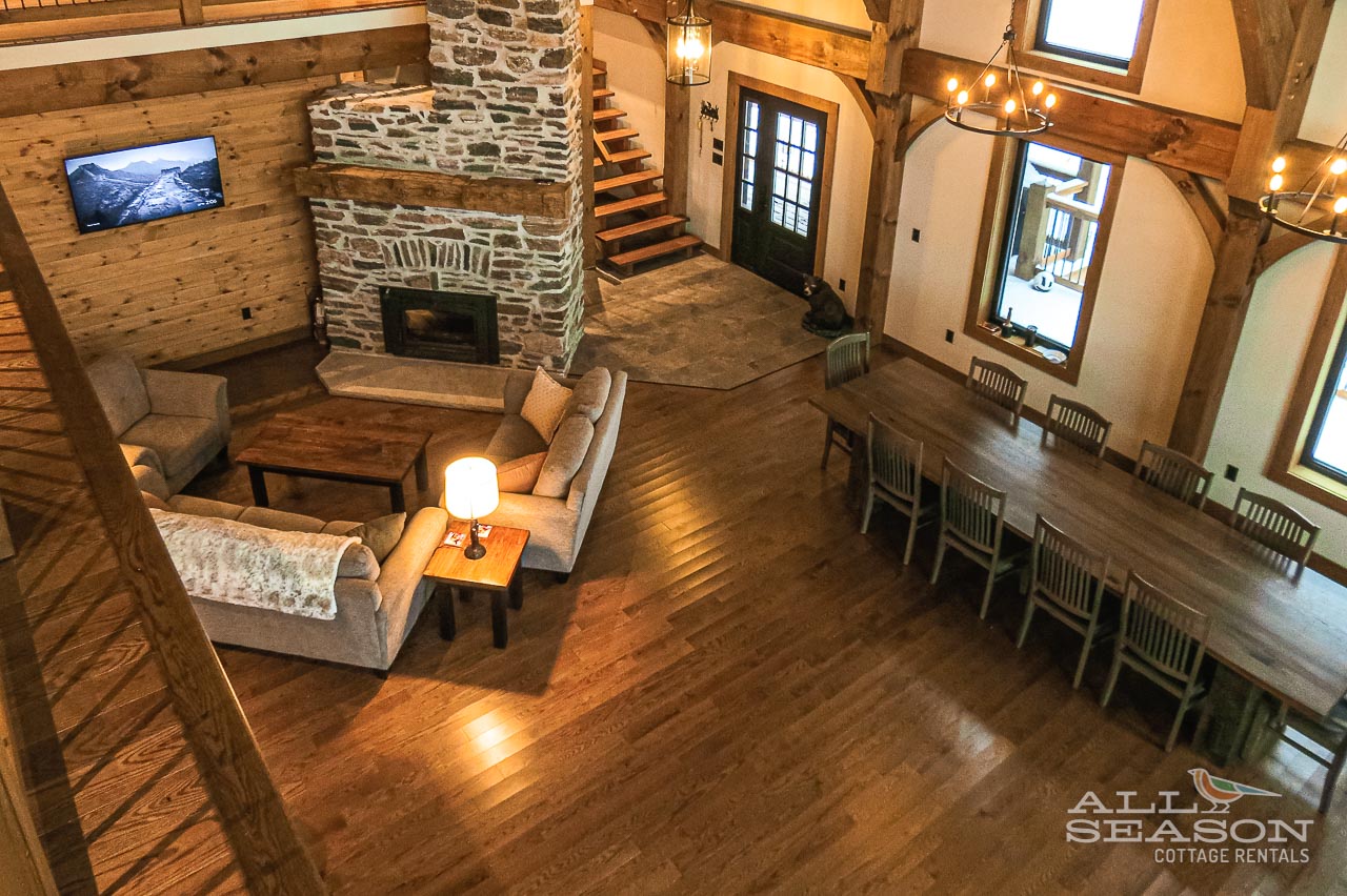 Gather around your cozy stone fireplace while the warm wood beams frame unforgettable moments in this rustic yet refined living space.