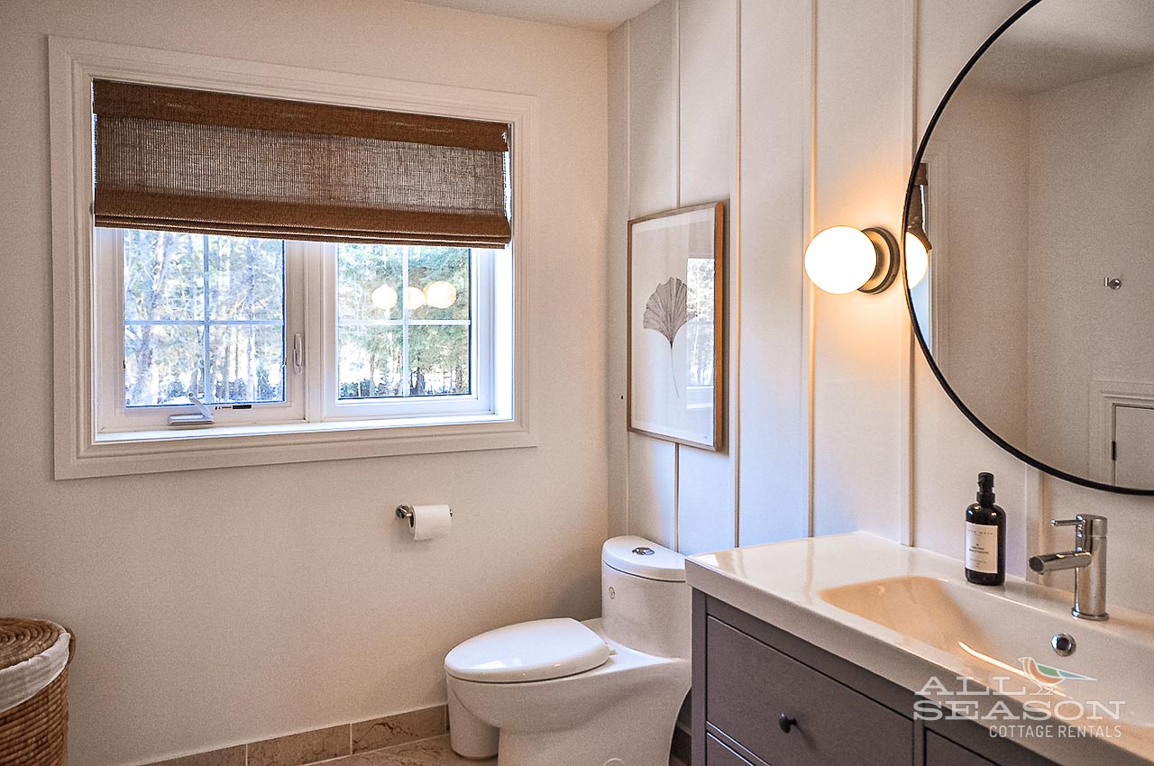 Your stylish bathroom features modern fixtures and a peaceful garden view for your morning routine.