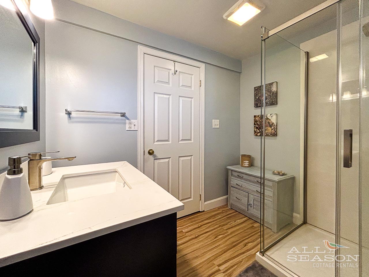 Step into your beautifully renovated bathroom featuring elegant marble countertops, spacious glass shower, and modern fixtures for your comfort.