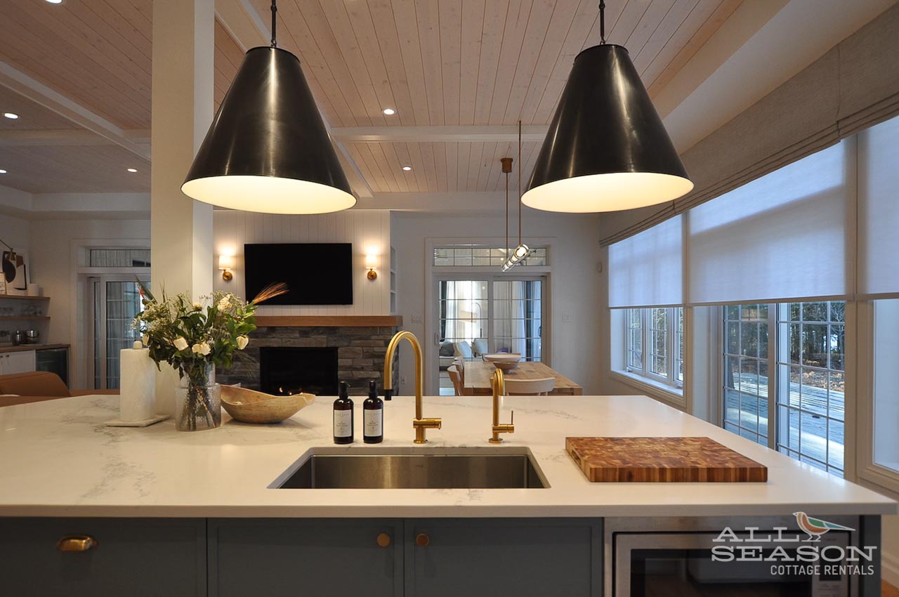 Your gourmet kitchen flows seamlessly into the cozy living space, where you can cook while staying connected with family around the fireplace.