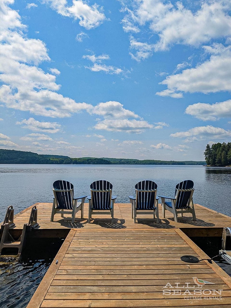 Settle into your private dock with four Adirondack chairs facing the tranquil lake, where peaceful afternoons blend seamlessly into stunning evening views.