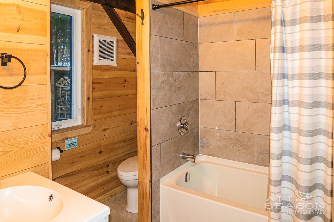 Unwind in your rustic bathroom with modern touches—enjoy a relaxing soak in the tub after mountain adventures.