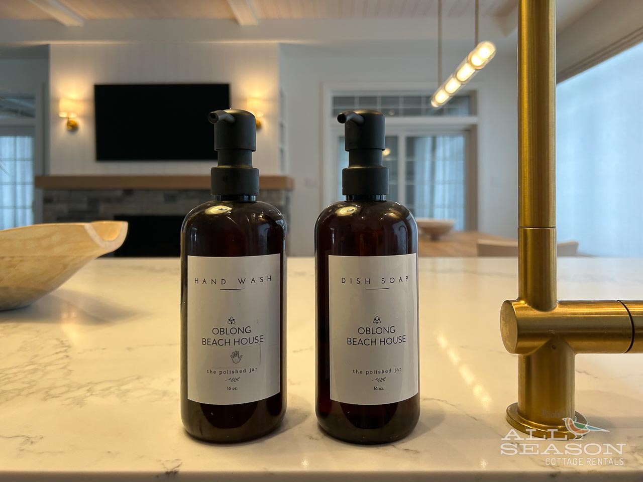 Luxurious branded hand wash and dish soap await you at this elegantly appointed kitchen sink with gleaming gold fixtures.