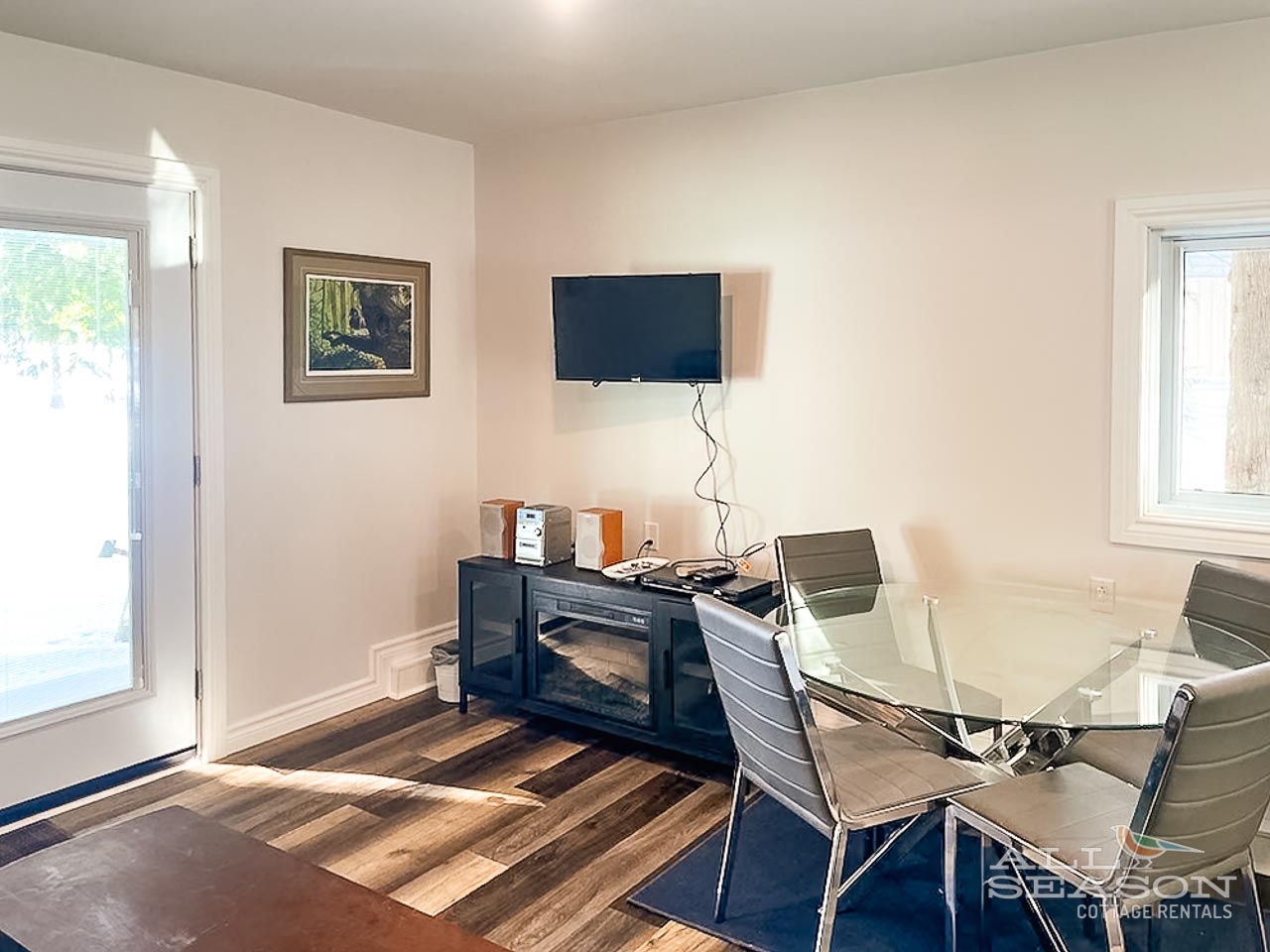 Gather around your sleek glass dining table where modern meets comfort with stylish seating for four and warm fireplace ambiance.