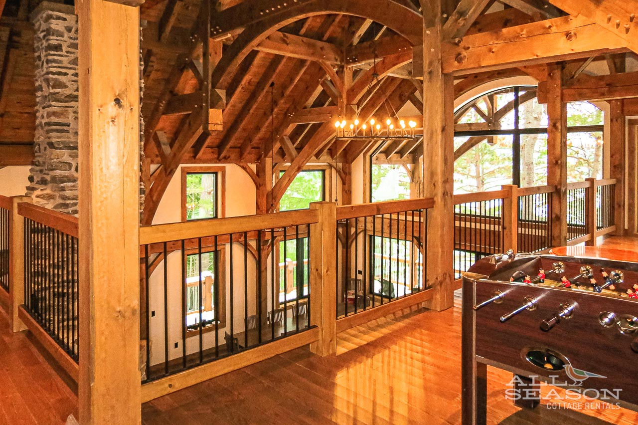 Challenge friends to foosball in this stunning timber-framed loft with soaring beams and natural light streaming through arched windows.