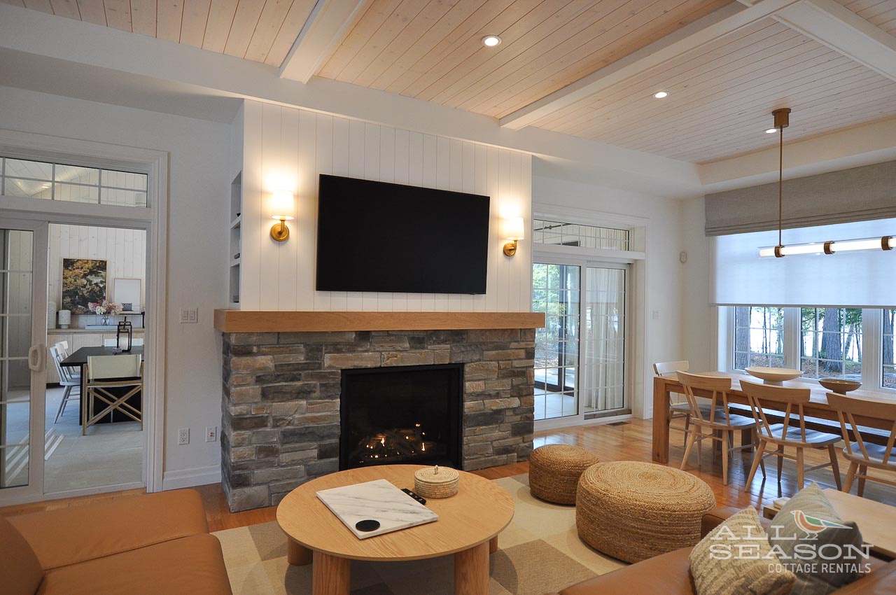 Unwind in your spacious living room where rustic stone fireplace meets modern comfort, perfect for cozy evenings together.