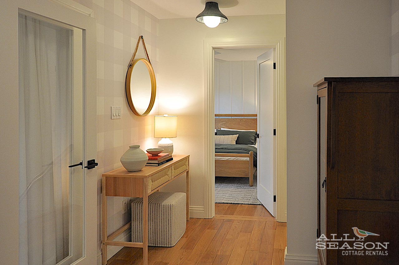 A welcoming hallway connects your spaces with thoughtful touches like warm wood furniture and gentle lighting to create a homey atmosphere.