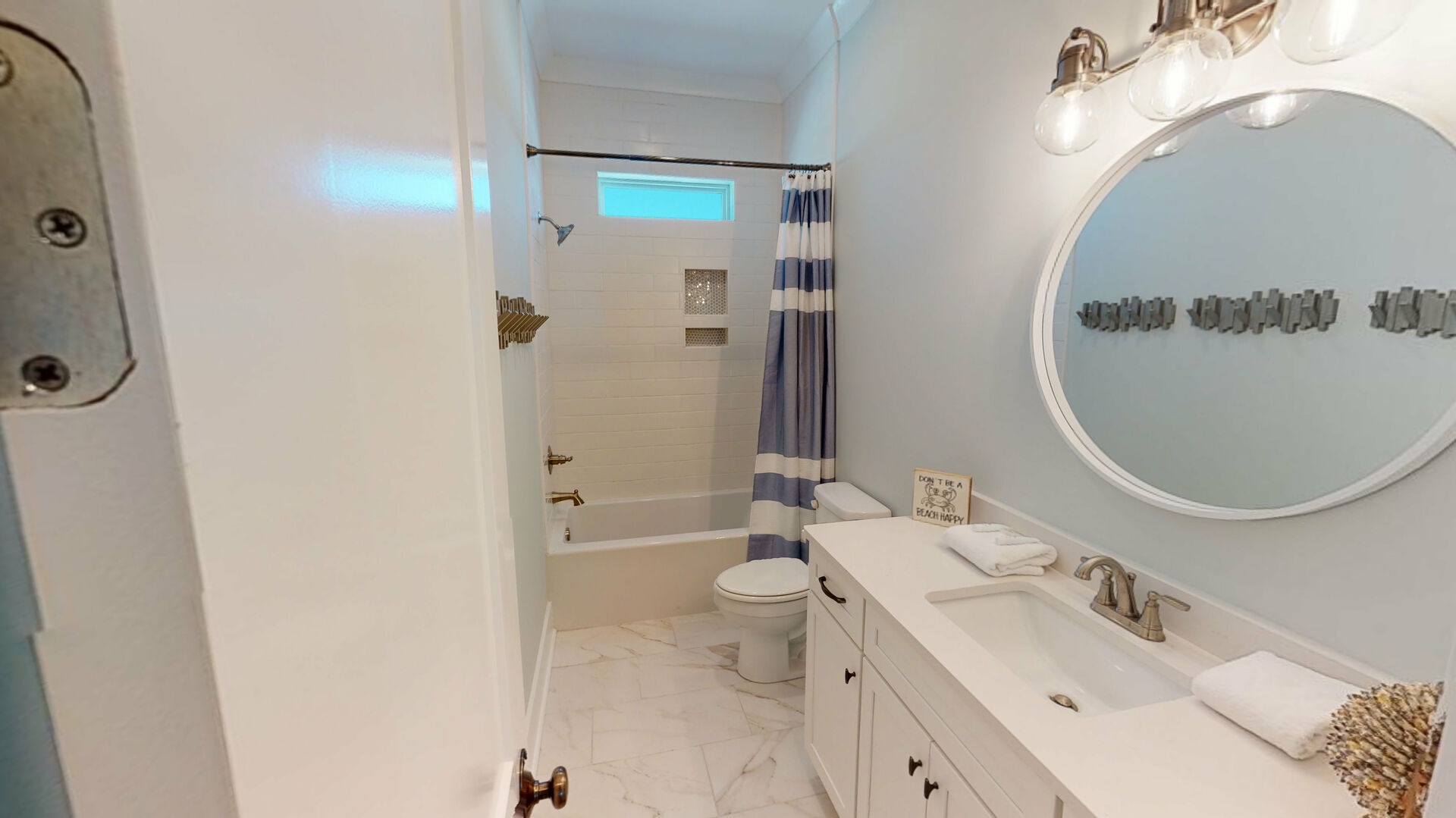 Bunkroom bath located near 2nd living area.  Guests in both bunkrooms share this space
