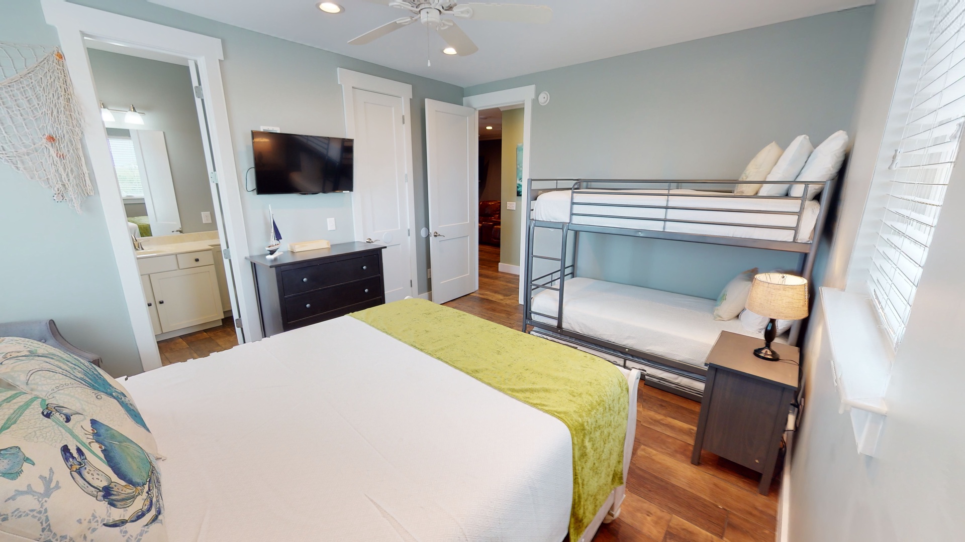 Bedroom 3 comes with a queen bed, twin bunk bed with a twin pull-out trundle, TV and a private bathroom