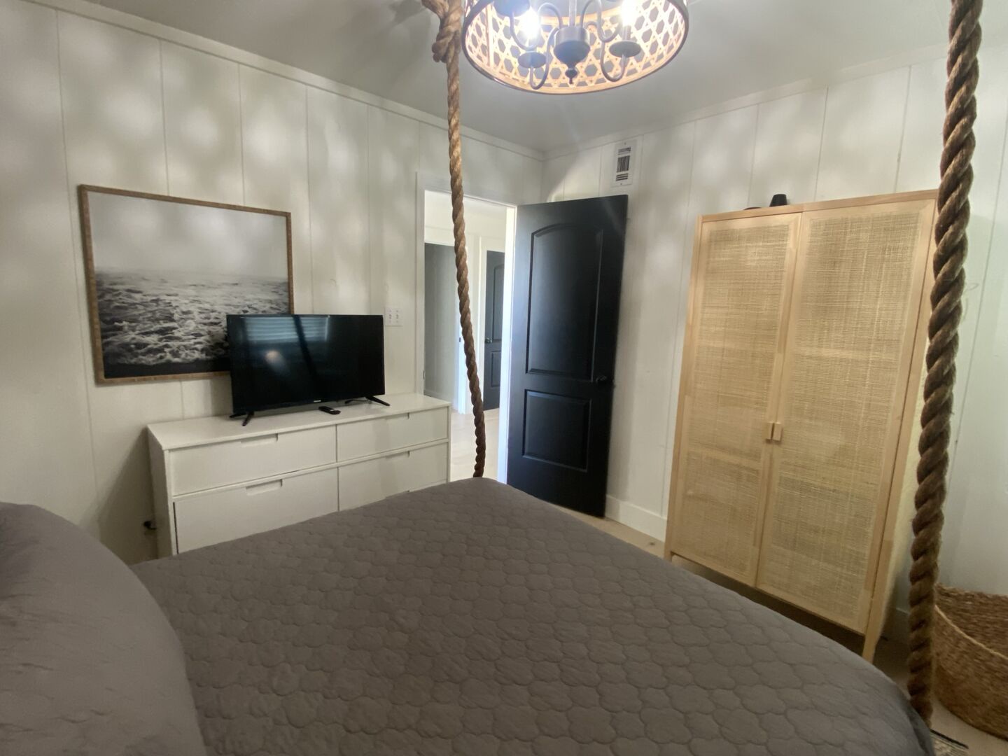 Main level, bedroom 2, king bed, TV, shares hall bath