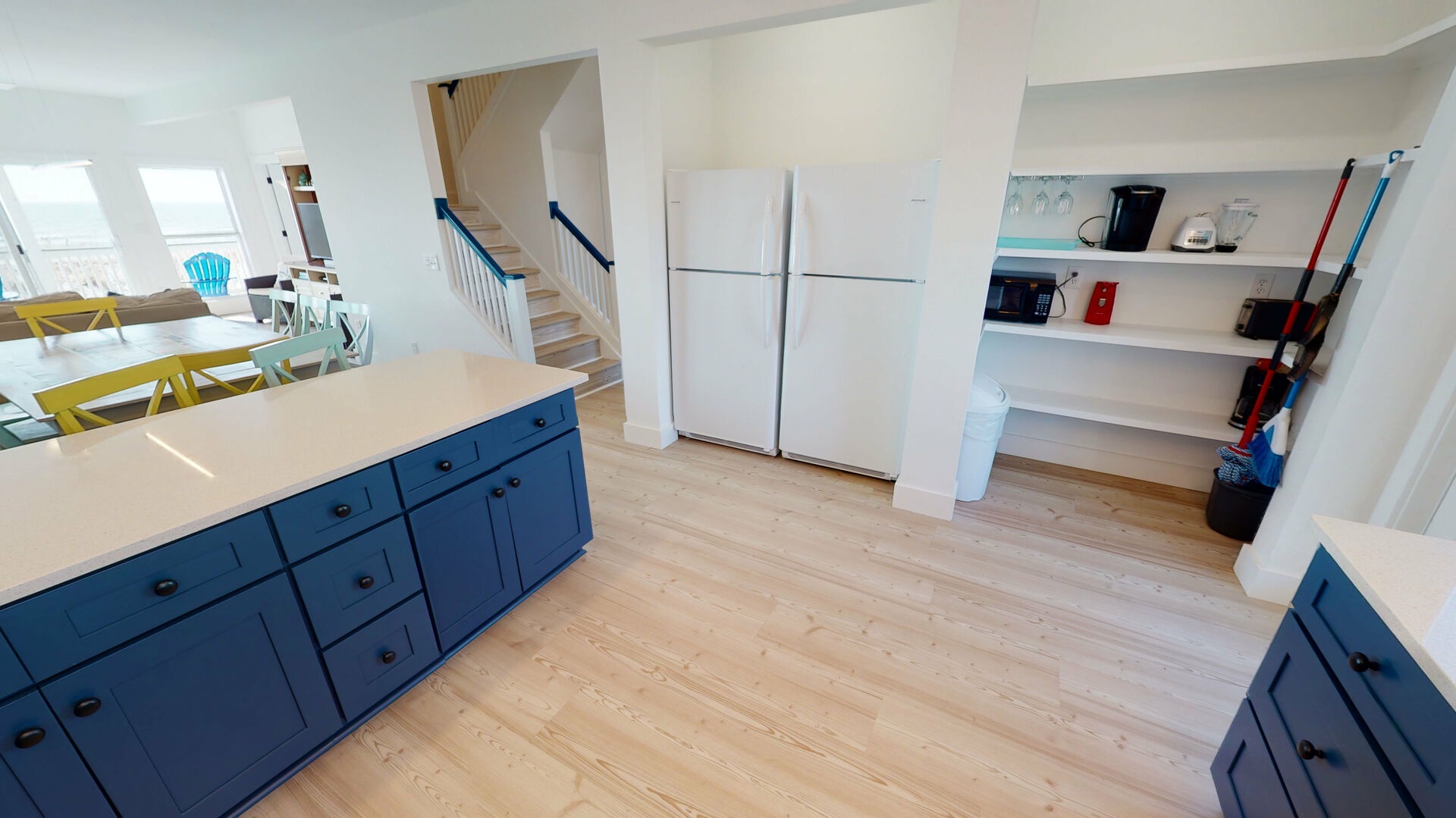 This updated kitchen features 2 refrigerators and a large pantry