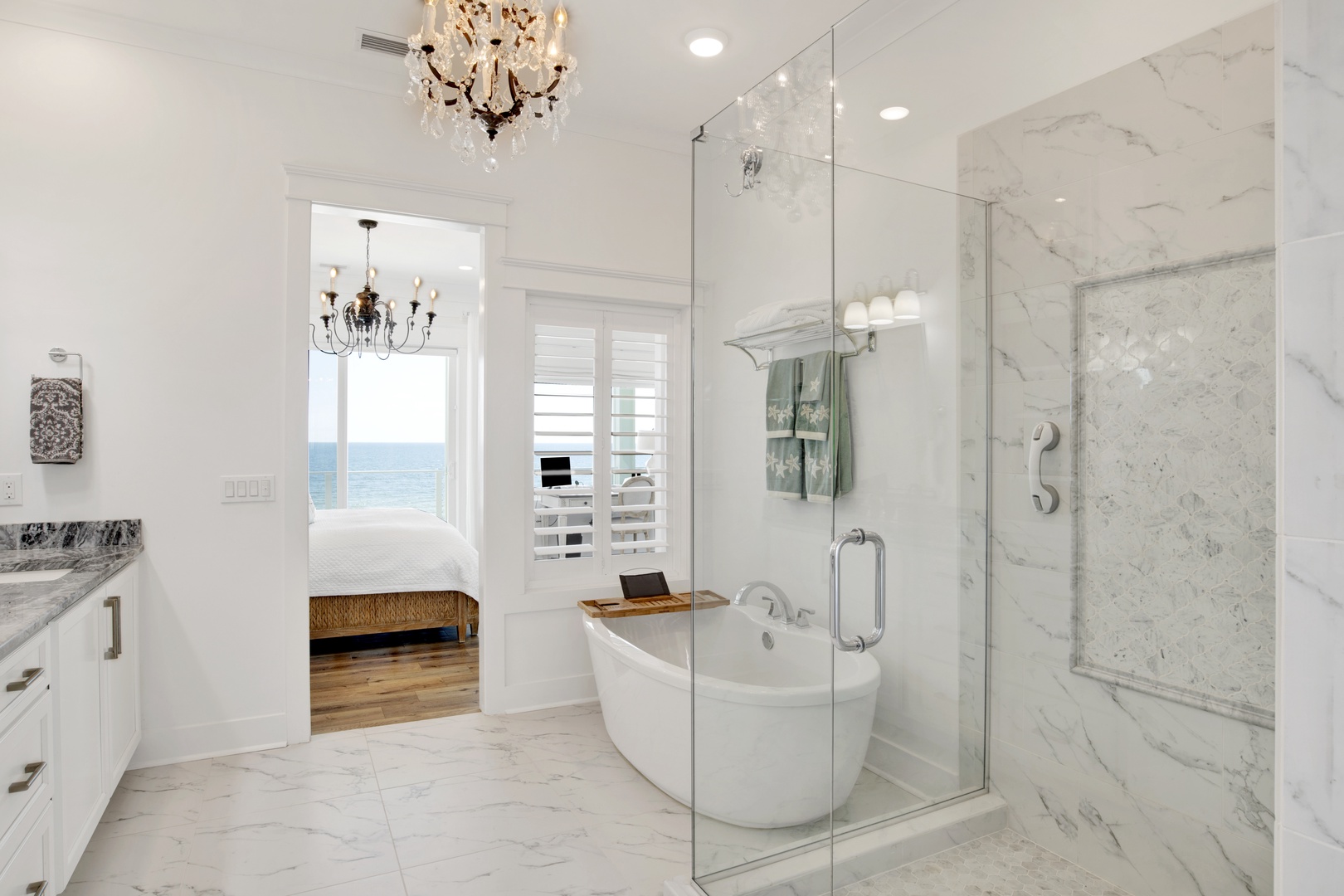 The master bath features a soaking tub with views of the Gulf