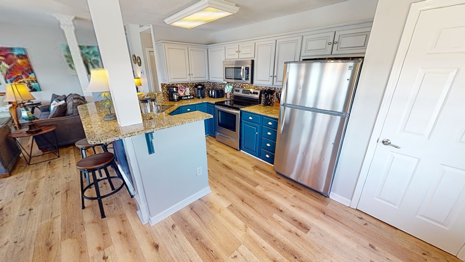 Updated kitchen with stainless appliances, granite countertops and tile backsplash