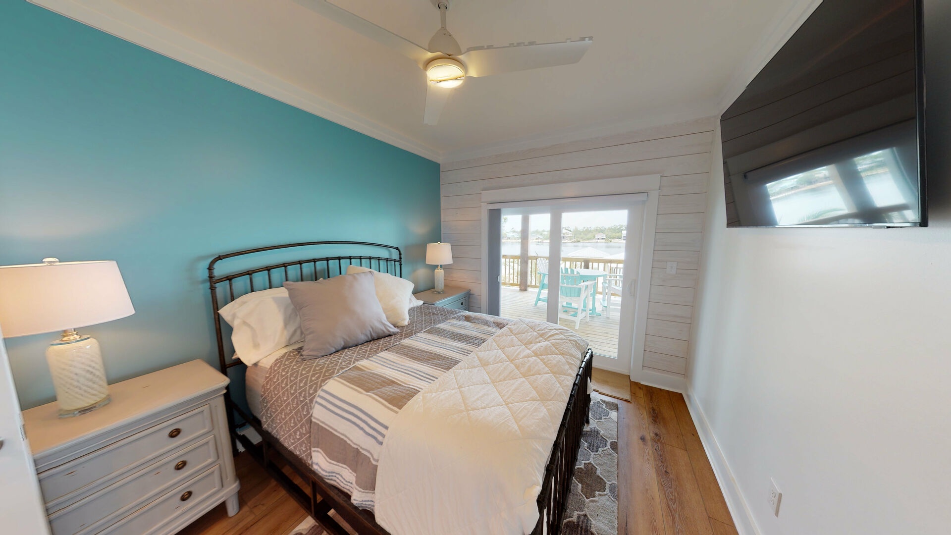 Bedroom #3 is on the 2nd floor with a king bed, TV, water views, balcony access and attached bathroom