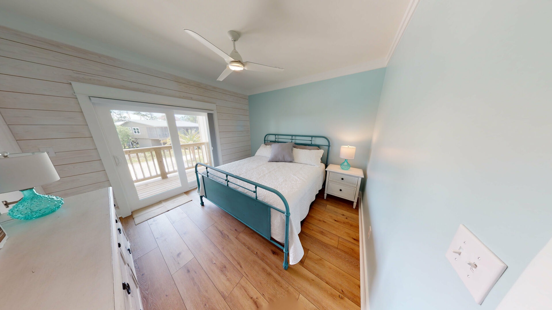 Bedroom #4 has a queen bed, water views, balcony access and a TV, located on the 2nd floor