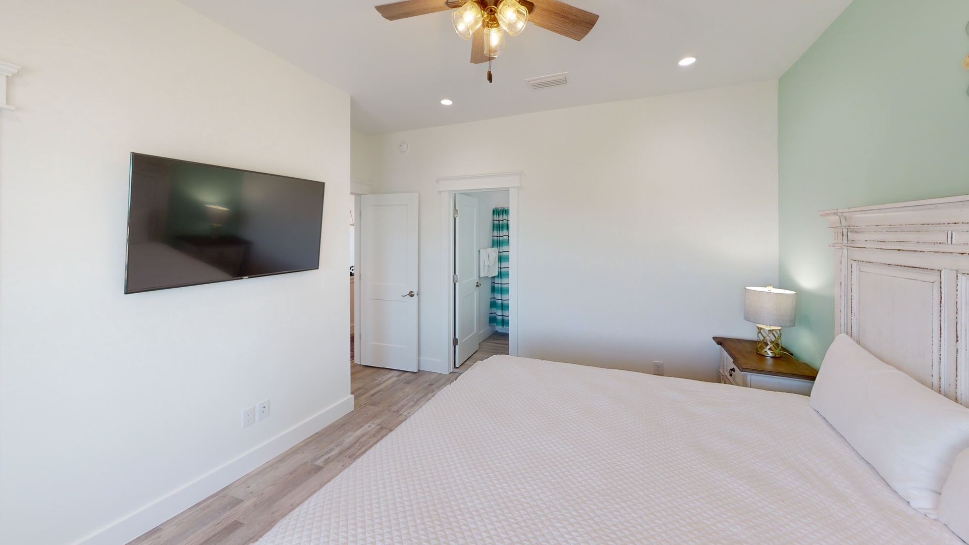 Bedroom 5 has a television, ceiling fan and a door to 2nd floor pool side balcony