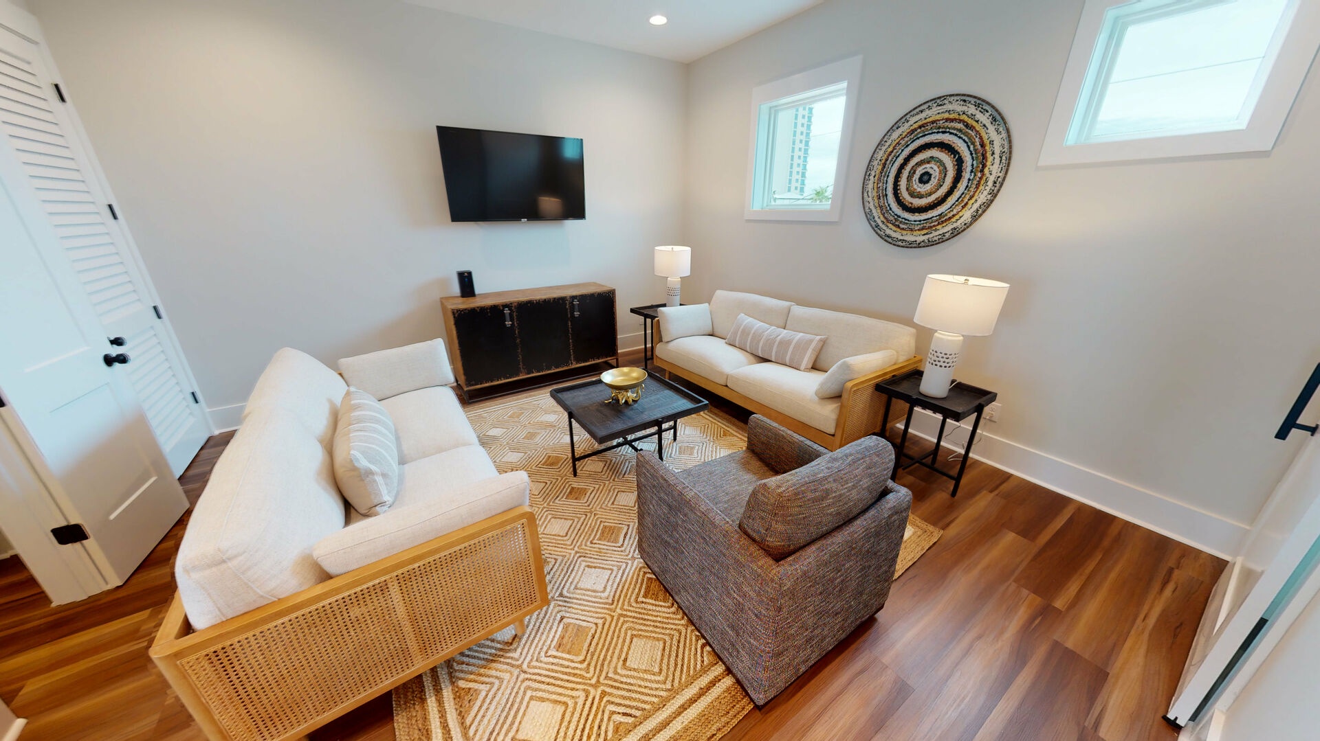 This living area provides comfortable seating and a mounted smart TV