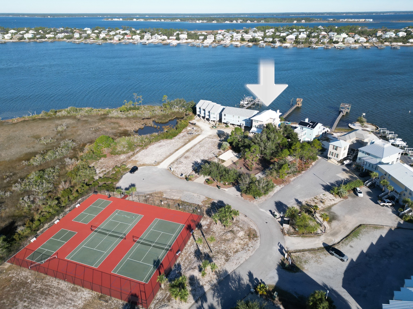 Blue Heron is a multi-level home on Old River with community tennis and pickle ball courts