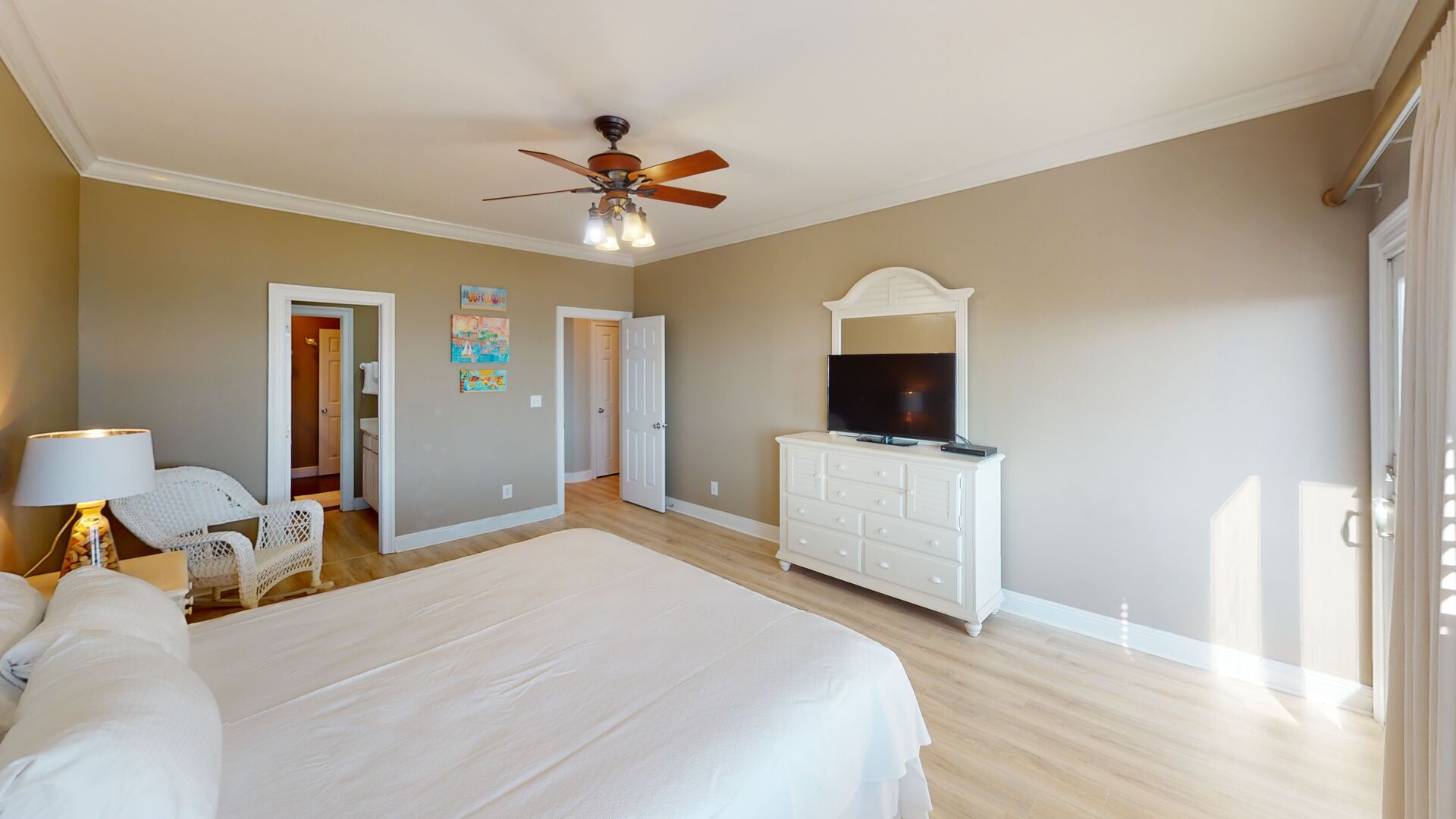 Bedroom 5 has a TV, Gulf views, balcony access and an attached bath with a hall entrance