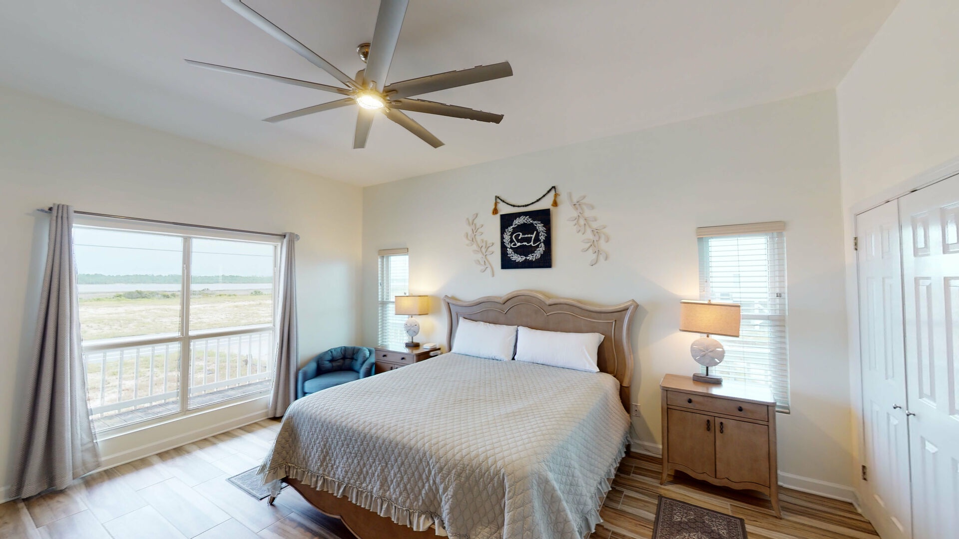Bedroom #2 has a king bed, ceiling fan and lagoon views